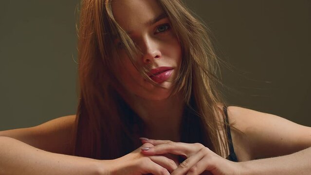 Natural woman beauty. Alluring sensual young girl with waving healthy hairs. Haircare cosmetics ad. ProRes codec