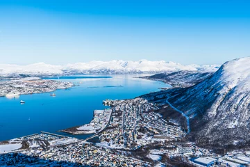 Wandaufkleber Incredible View to Tromso city in Norway from Storsteinen peak, a mountain ledge about 420 m (1378 ft) above sea-level, on a sunny winter day, copy space © Daniela Baumann