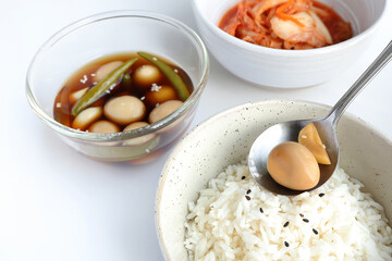 Korean braised quail eggs. Soy sauce braised quail eggs on the table served with rice. Korean food style