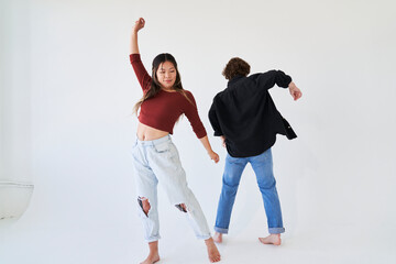 woman arm up dancing with man facing away
