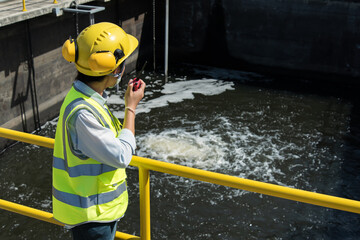 Wastewater treatment concept. Service engineer on waste water Treatment plant and checking oxygen in water with tablet. - obrazy, fototapety, plakaty