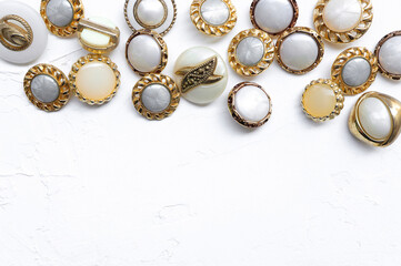 set of vintage buttons on white concrete background. Craft and needlework concept. empty space for text.