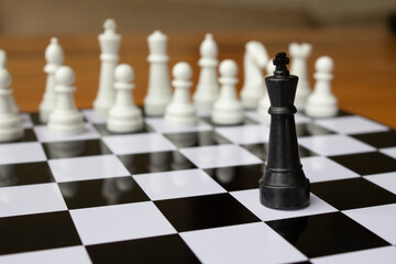 The chess king is alone against all pieces. Team game concept. There is safety in numbers.