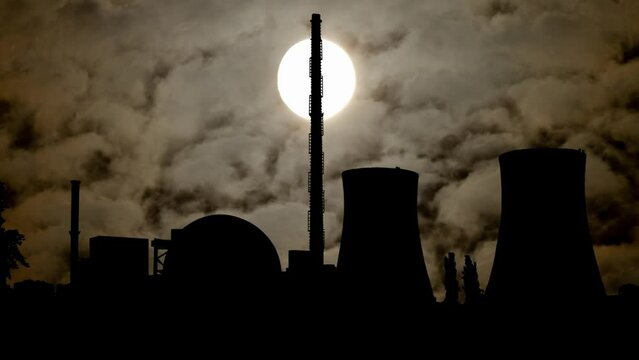 Nuclear Power Station by Night with Dark Atmosphere, Fog, Smoke and Full Moon, Atomic Danger Concept