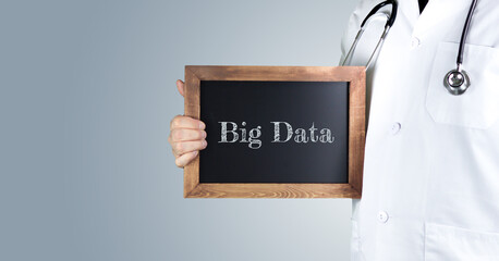Big Data im Gesundheitswesen. Arzt zeigt Begriff auf einem Holz Schild. Handschrift auf Tafel