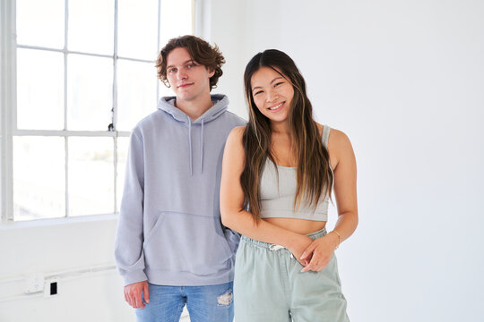 couple athletic streetwear by large window