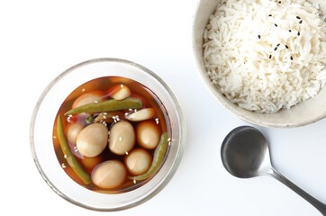 Korean braised quail eggs. Soy sauce braised quail eggs on the table served with rice. Korean food style