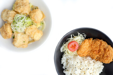 Tonkatsu taken serve with rice. Pork cutlet and shredded cabbage on a plate and fish fried serve with rice on the table. japanese food style