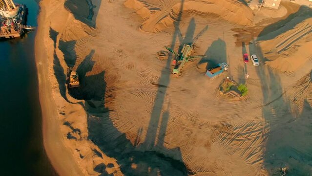Bird's-eye view. Scene.Large trucks on an empty desert terrain reproduce construction work.