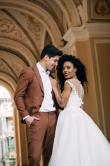 Luxurious wedding couple. Clear, even skin. Photo shoot outdoors with natural light. Portrait of a couple in love in wedding attire.