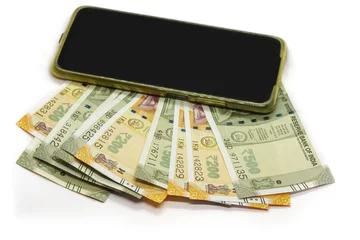 Fotobehang Closeup shot of 200 and 500 Indian rupees and a mobile phone isolated on a white background © Arun Kumar/Wirestock Creators