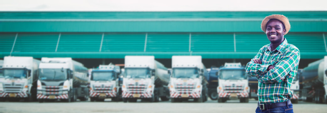 African Truck Driver Standing And Smiling Confident In Insurance Cargo Lorry In Long Transportation And Delivery Business