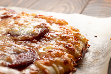 Hot baked pepperoni pizza on baking paper