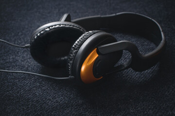 Large headphones on dark fabric with a place for writing