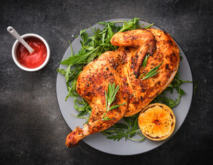 Half roasted chicken Piri Piri served with lemon and sauce . Grilled poultry - 495633963