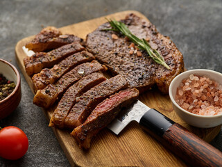 Grilled top sirloin or cup rump beef meat steak on wooden board.Picanha, traditional Brazilian...