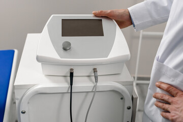 Closeup photo of professional physiotherapist with radio frequency transporter machine