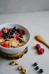 Delicious and healthy breakfast. Natural yogurt, cereals and berries. Wooden spoon.
