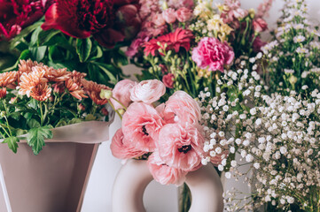 Different kinds of summer flowers such as ranunculus, lilies, peonies, chrysanthemums, gypsophila, carnations, lisianthus. Many flower bouquets after birthday party