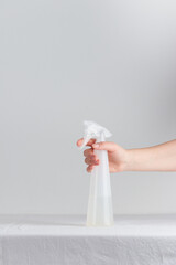 Woman hand with spray bottle