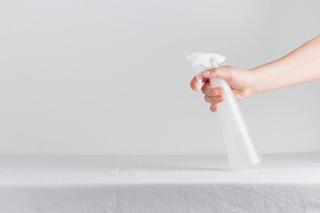Woman hand with spray bottle