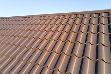 Closeup of house roof top covered with metallic shingles
