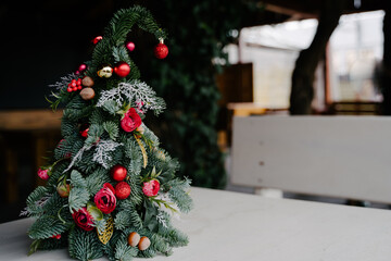 Floral Christmas tree handmade. Red toys and flowers.