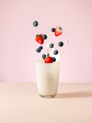 Milkshake . Glass with milk. Yogurt with fresh fruits and berries. Levitation. Splashes 