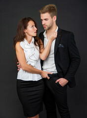 young successful businessman and businesswoman on black background, cooperation