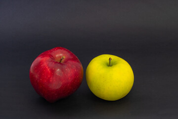 Fruits on a black background. Green and red apple on a black background.