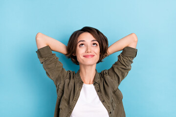 Photo of optimistic young bob hairdo lady hands head look up wear outfit isolated on blue color background