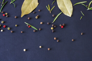 Peppercorns on a black background, peppercorns of different colors