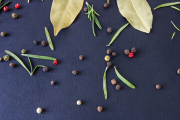 Peppercorns on a black background, peppercorns of different colors