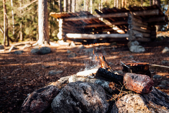 Grill hot dogs in the forest at a wind protection