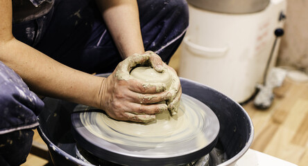 Woman Pottery Artist. Molding Clay On Pottery Wheel At Art Workshop . Ceramic Studio. Closeup View. Female Hands Shapes Clay.	