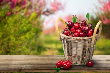 Fototapeta na wymiar Fresh ripe cherries on a wooden table on natural background