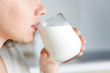 Young woman is drinking milk