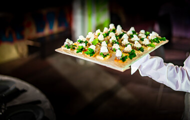 waiter holds tray with food. Restaurant service. buffet or catering.