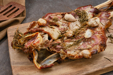 Roasted lamb shoulder with garlic, rosemary. Lamb meat, shoulder of mutton with spices. Lamb leg...