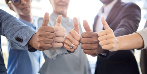 Theres always success at the end of hard work. Closeup shot of a group of unrecognisable businesspeople showing thumbs up together in an office.