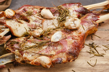 Roasted lamb shoulder with garlic, rosemary. Lamb meat, shoulder of mutton with spices. Lamb leg fillet ready to eat. Selective focus.