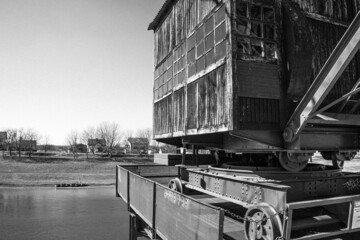 Grayscale of an old locomotive on the riverside