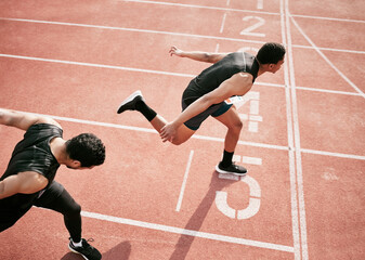 Hes stolen it. High angle shot of two handsome young male athletes crossing the finishing line...