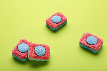 Red and blue tablets for dishwashing machine. Detergents for home hygiene. Dishwasher capsules on...
