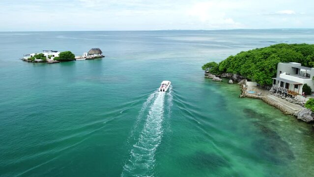 Aerial shot of a boat passing by Rosario Islands, Cartagena, Colombia