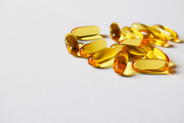 Omega three. Fish oil capsules on white.