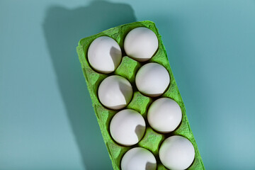 White chicken eggs in a  cardboard box.
