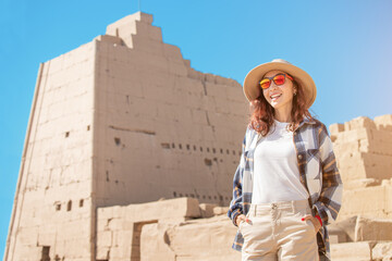 A female traveler explores the ruins of the ancient Karnak temple in the city of Luxor in Egypt....