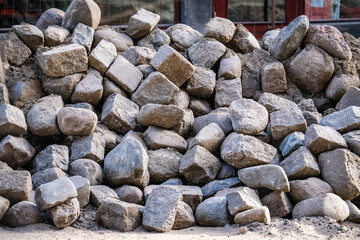 Road works. Stack with cobblestone, paving. Selective focus