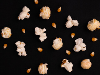 popcorn patern on a black background. corn kernels and popcorn